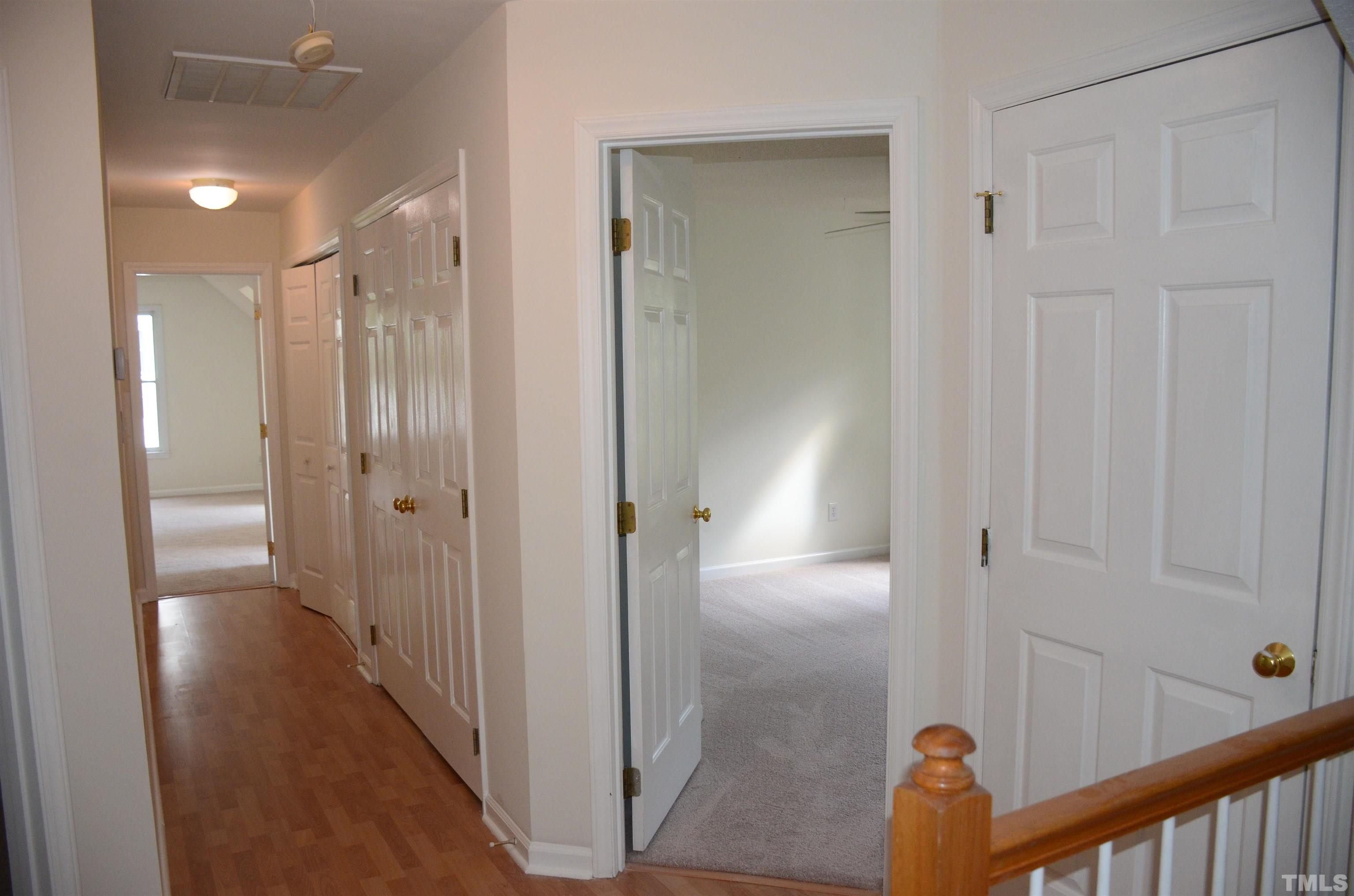 118 Covington Square Drive Cary, NC 27513 - Photo 37 of 58 a view of a hallway with wooden floor and staircase