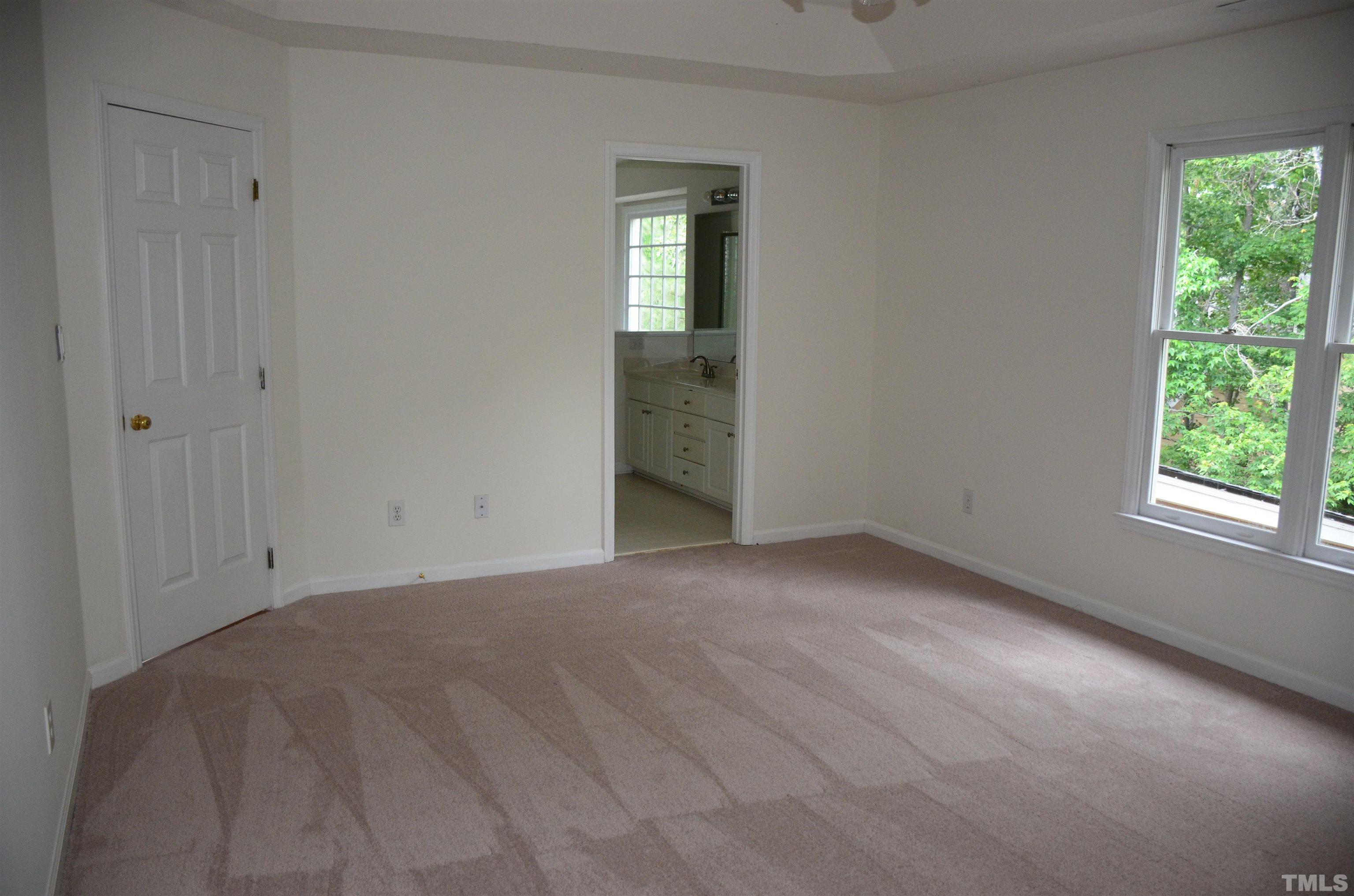 118 Covington Square Drive Cary, NC 27513 - Photo 42 of 58 a view of an empty room with wooden floor and a window
