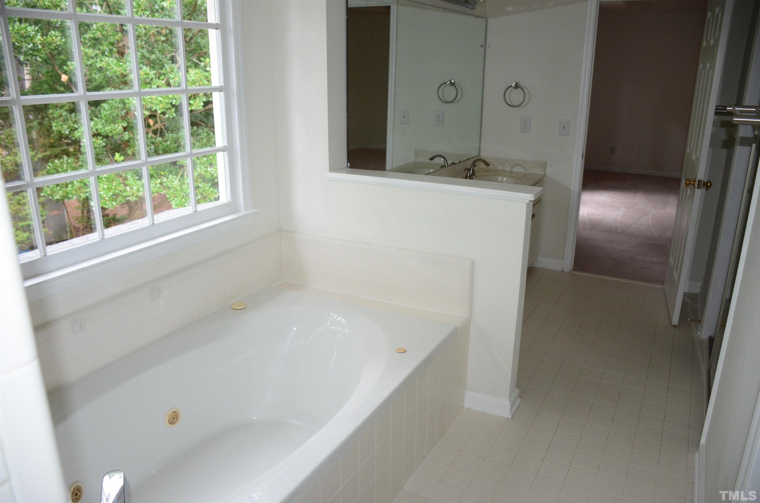 118 Covington Square Drive Cary, NC 27513 - Photo 46 of 58 a bathroom with a bathtub and a sink