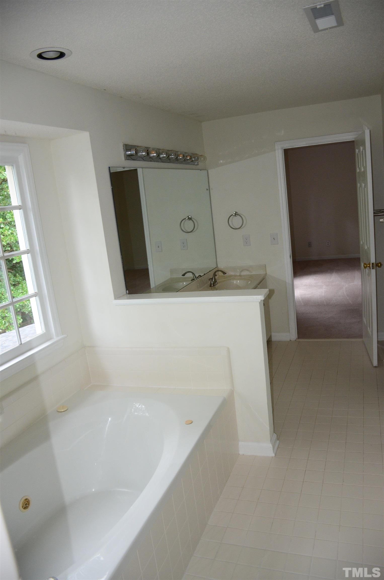 118 Covington Square Drive Cary, NC 27513 - Photo 47 of 58 a bathroom with a bathtub and a sink