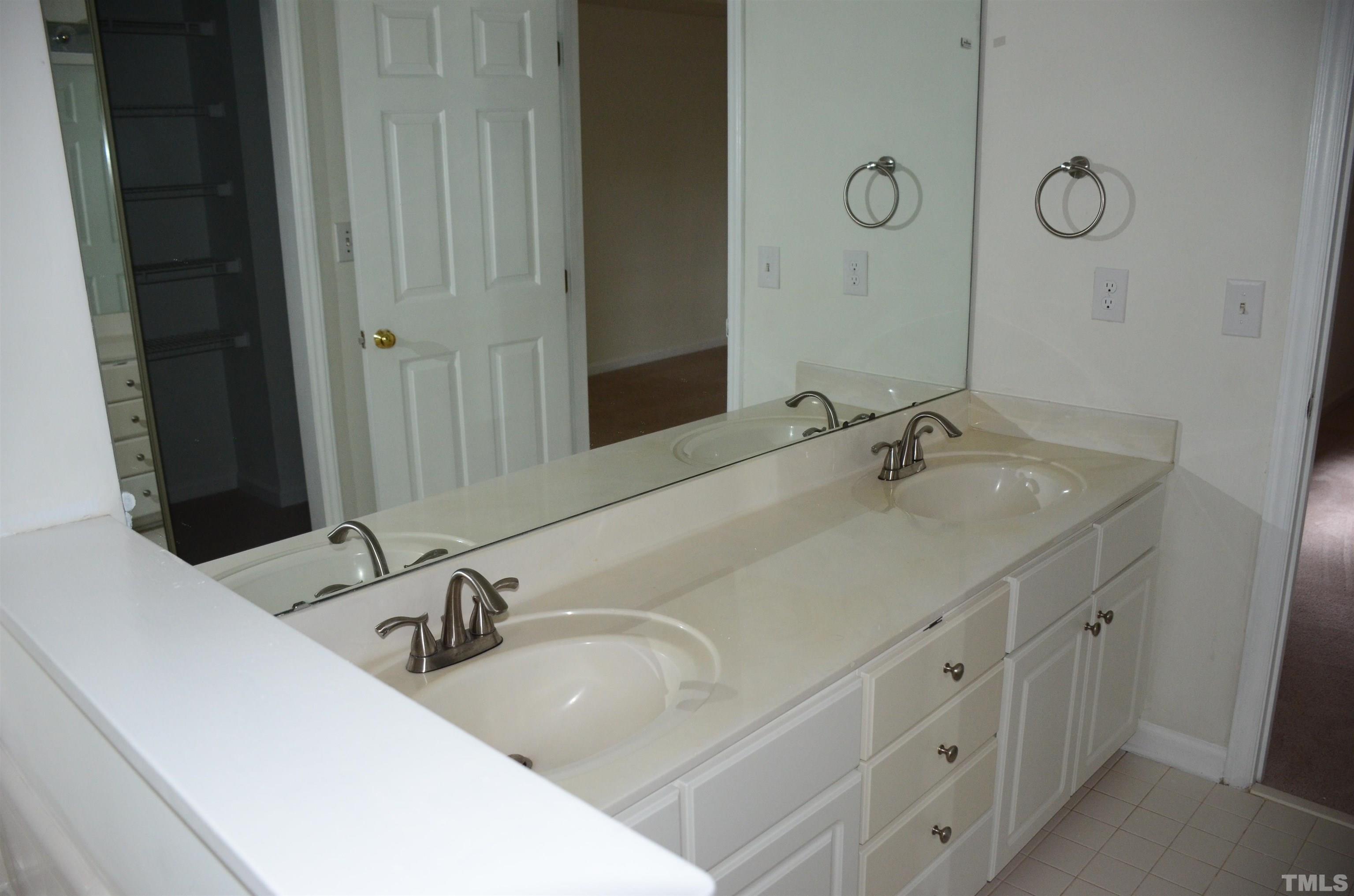 118 Covington Square Drive Cary, NC 27513 - Photo 48 of 58 a bathroom with double vanity sink and a mirror