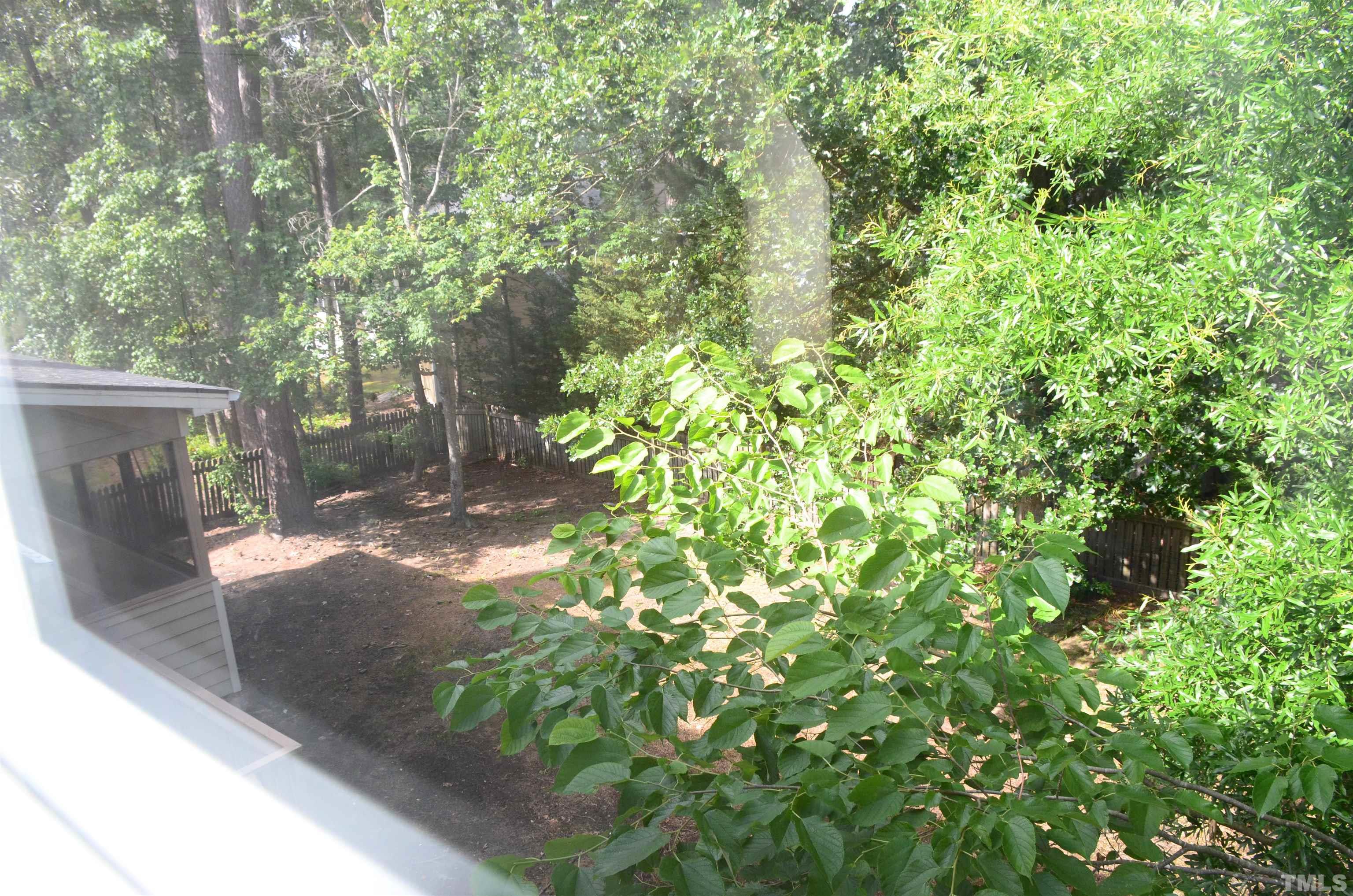 118 Covington Square Drive Cary, NC 27513 - Photo 57 of 58 a backyard of a house with large tree