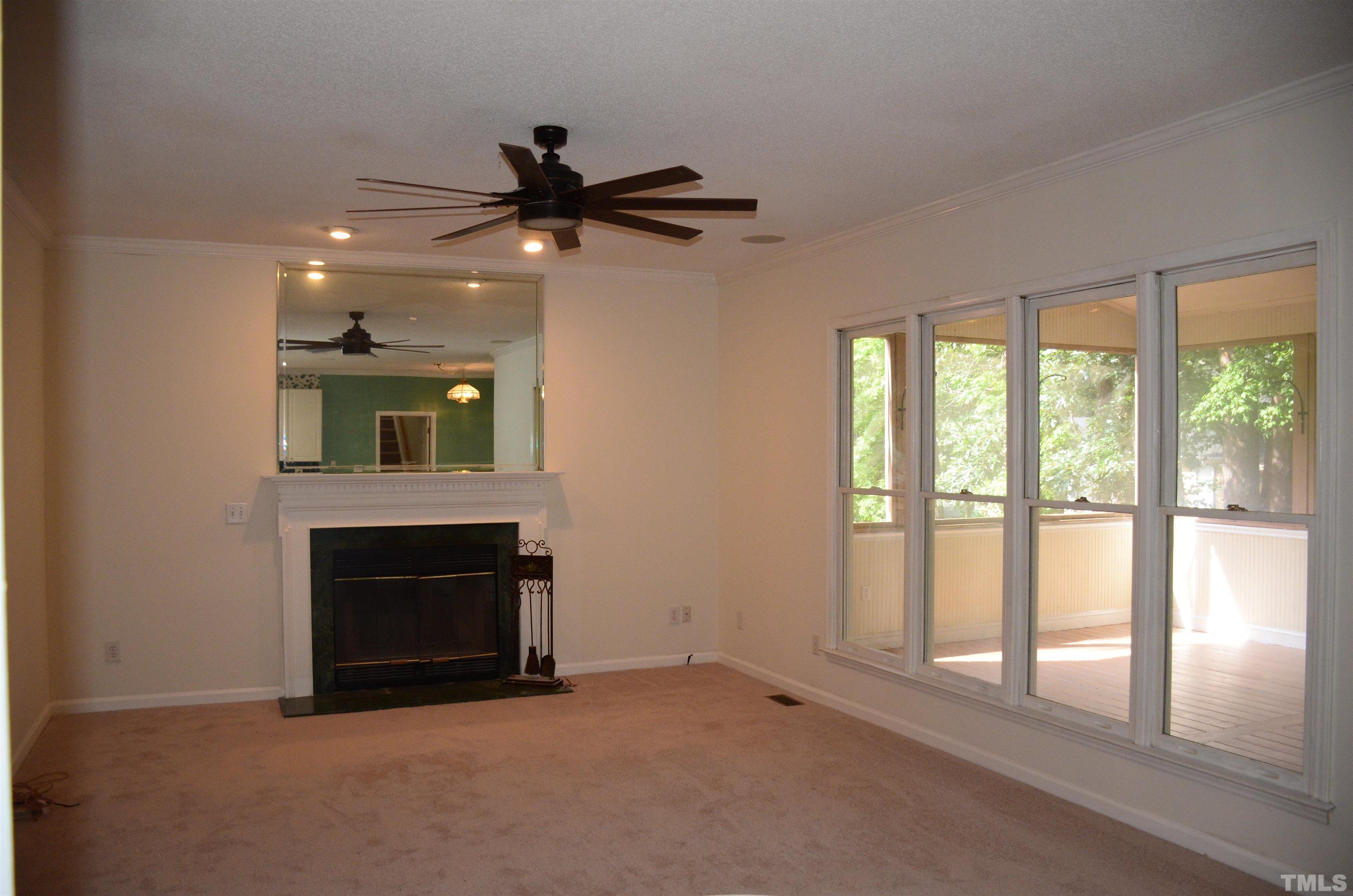 118 Covington Square Drive Cary, NC 27513 - Photo 10 of 58 an empty room with fireplace and windows