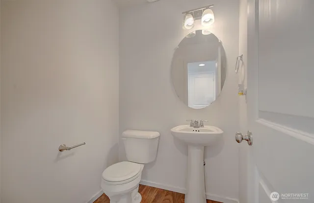 a bathroom with a sink toilet and a mirror