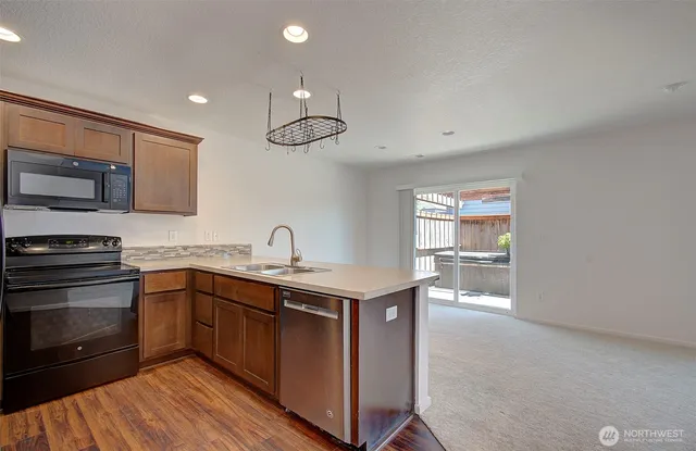 a kitchen with a sink a stove and cabinets