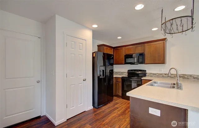 a kitchen with refrigerator a sink and cabinets