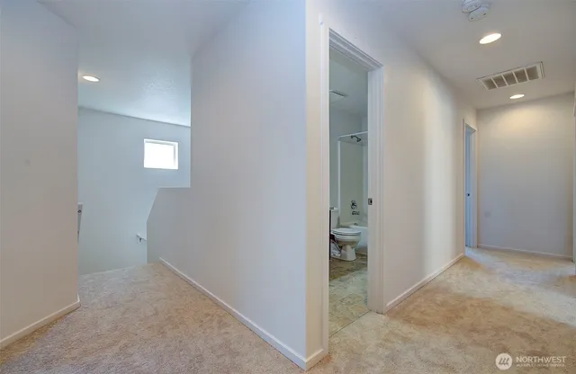 an empty room with closet and mirror