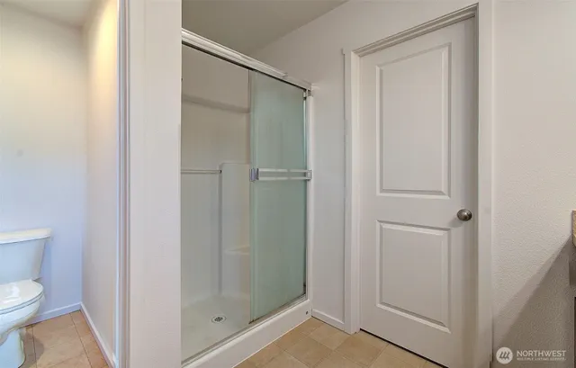 a bathroom with a shower and toilet