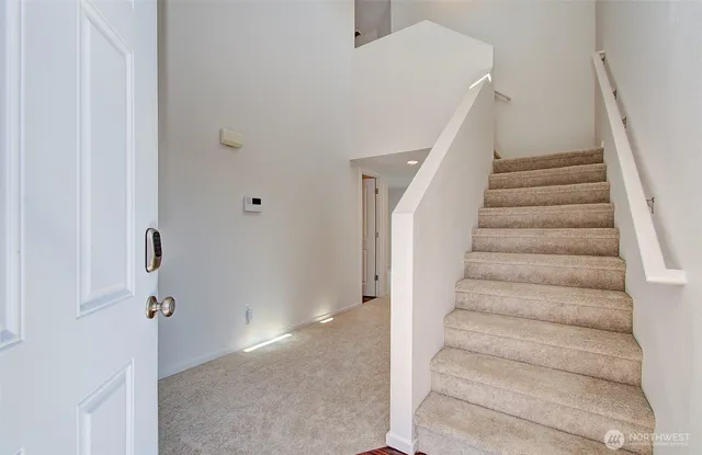 a view of staircase with white walls