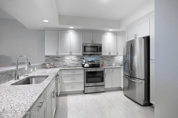 a kitchen with a sink stove and refrigerator