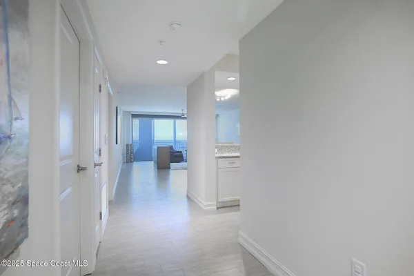 a view of a hallway with wooden floor