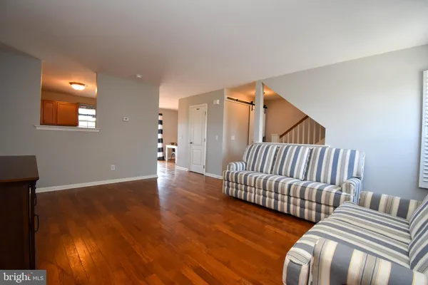a view of a livingroom with furniture and stairs