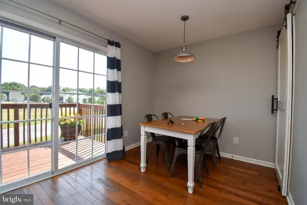 a view of a room with furniture wooden floor and next to a window
