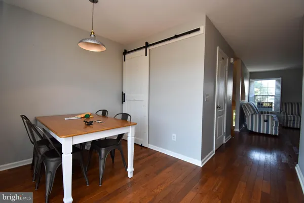 a view of a room with wooden floor windows and entryway