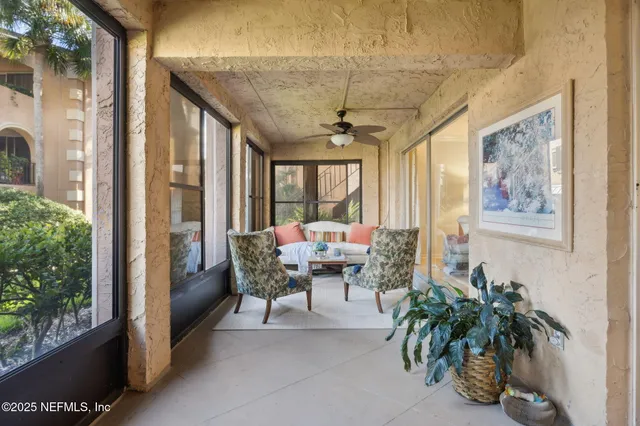 a living room with furniture and a potted plant