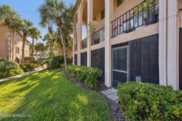 a view of a house with a yard and plants