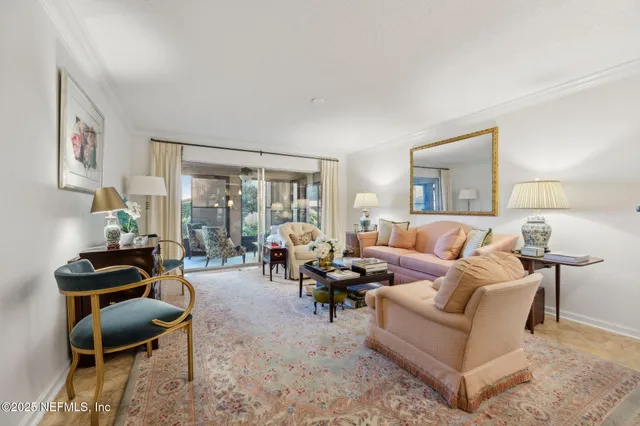 a living room with furniture a lamp paintings and a window