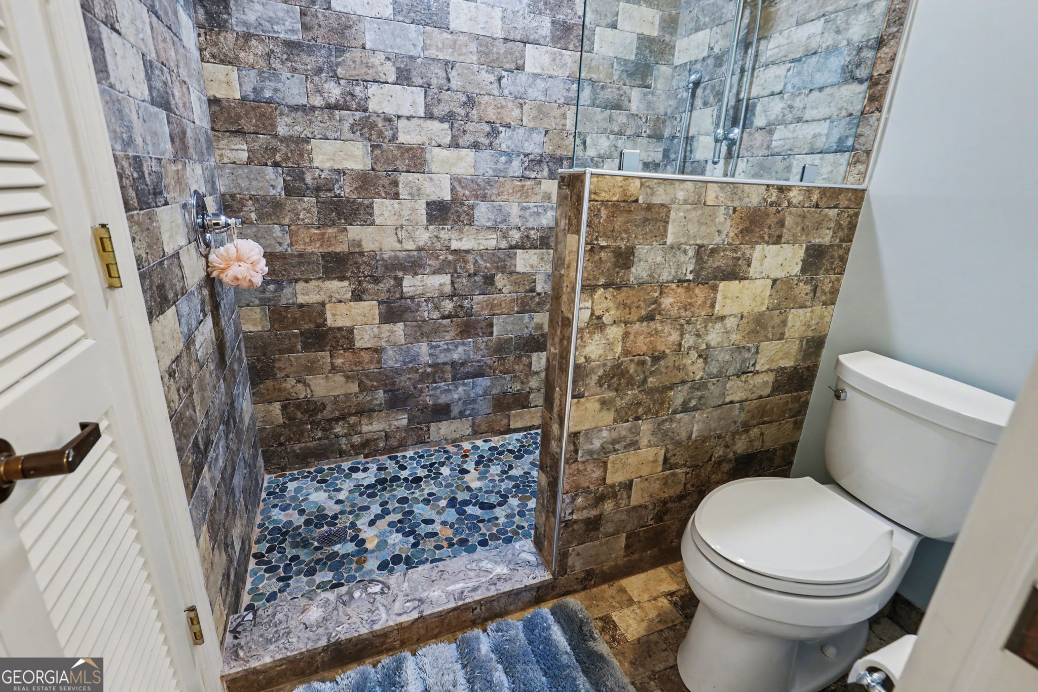 62 Sunvalley Circle, Unit 7006 Dillard, GA 30537 - Photo 32 of 55 a white toilet sitting next to a shower curtain