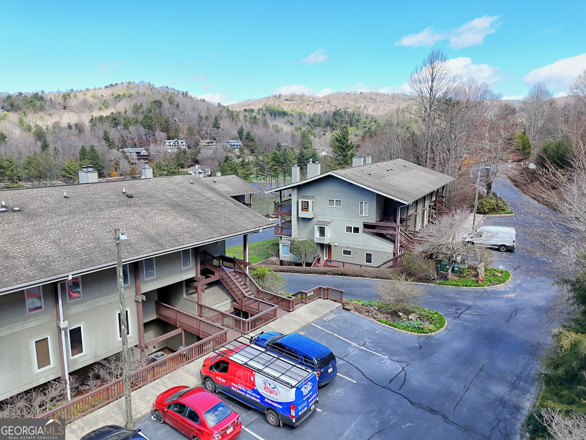 62 Sunvalley Circle, Unit 7006 Dillard, GA 30537 - Photo 54 of 55 an aerial view of a house roof deck with furniture and a garden