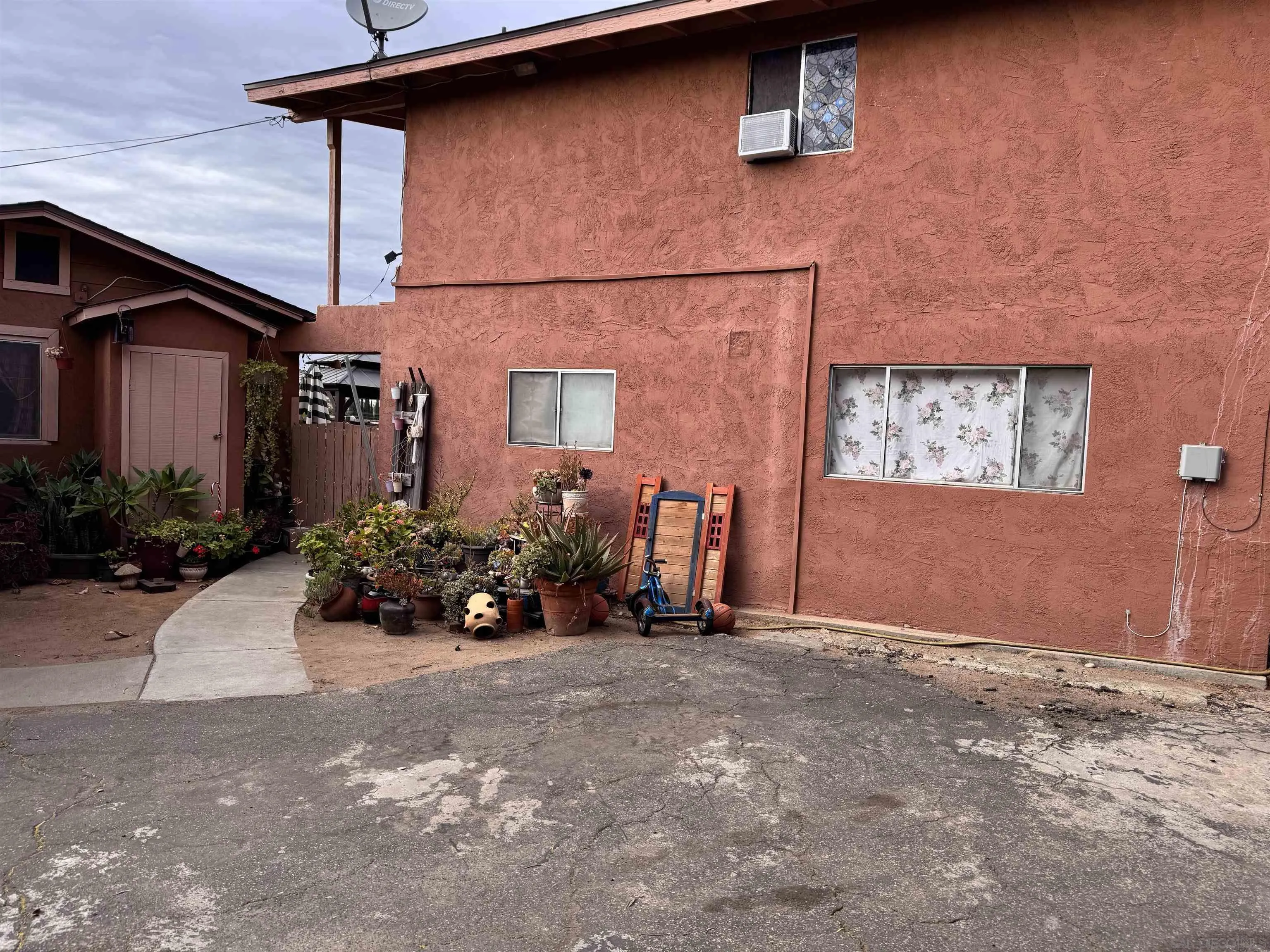 1708 East Mission Road Fallbrook, CA 92028 - Photo 6 of 13 a view of a house with a yard and potted plants