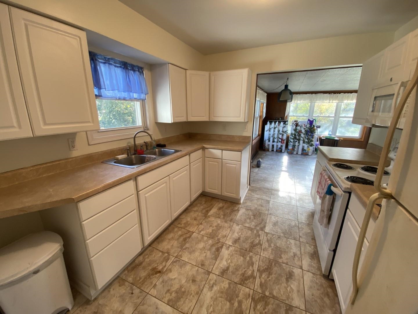 10361 Becker Road Savanna, IL 61074 - Photo 11 of 23 a kitchen with sink cabinets and window