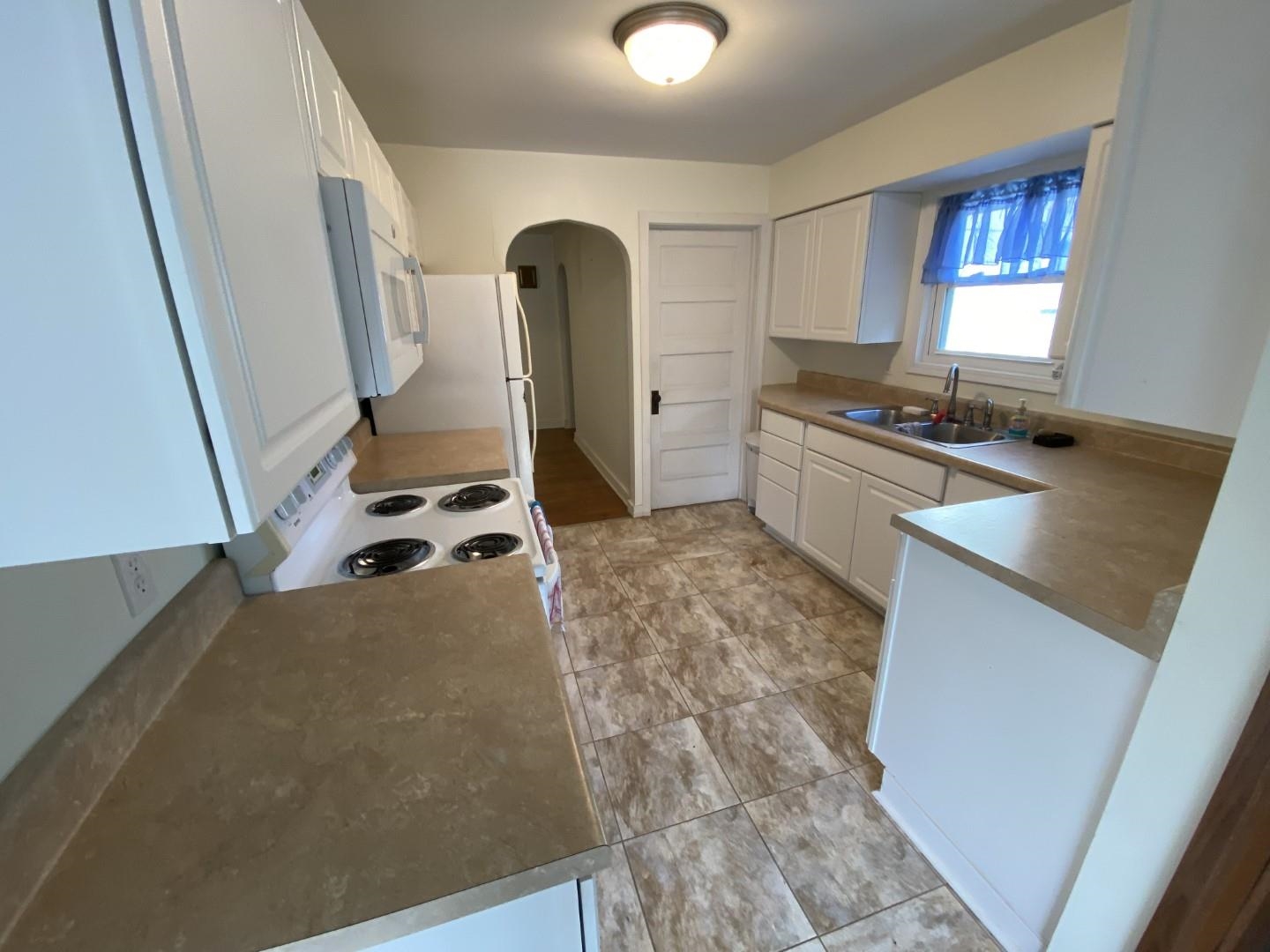 10361 Becker Road Savanna, IL 61074 - Photo 13 of 23 a kitchen with sink refrigerator and stove