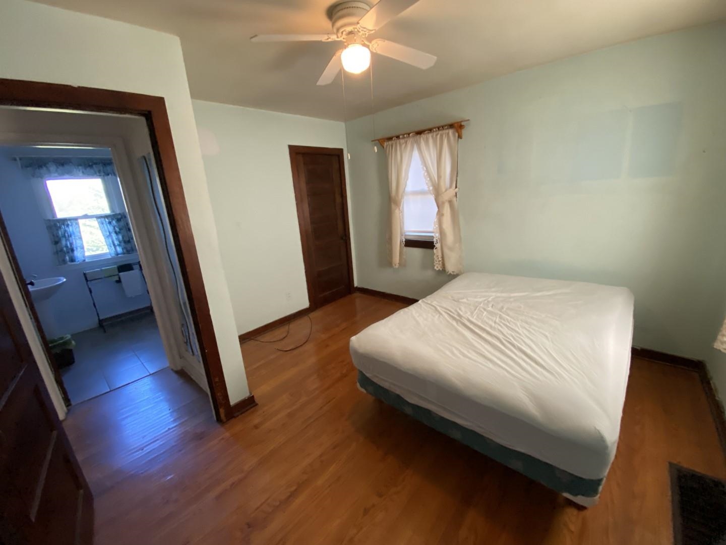 10361 Becker Road Savanna, IL 61074 - Photo 19 of 23 a bedroom with a bed and a mirror