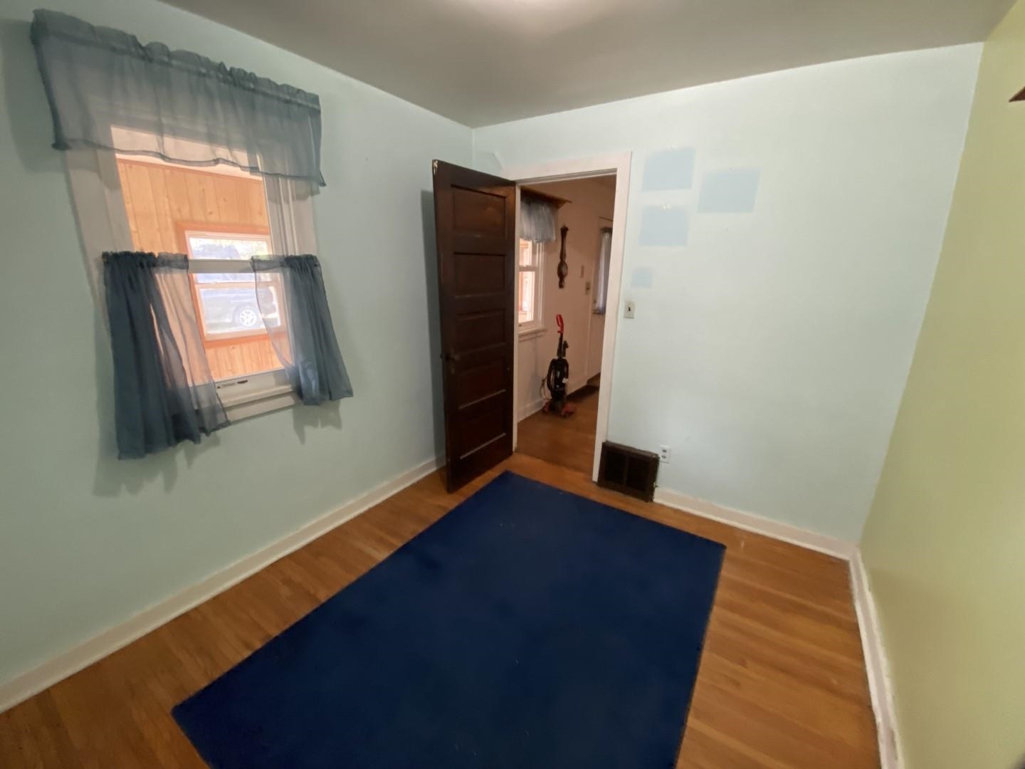 10361 Becker Road Savanna, IL 61074 - Photo 8 of 23 a view of an empty room with wooden floor and a window