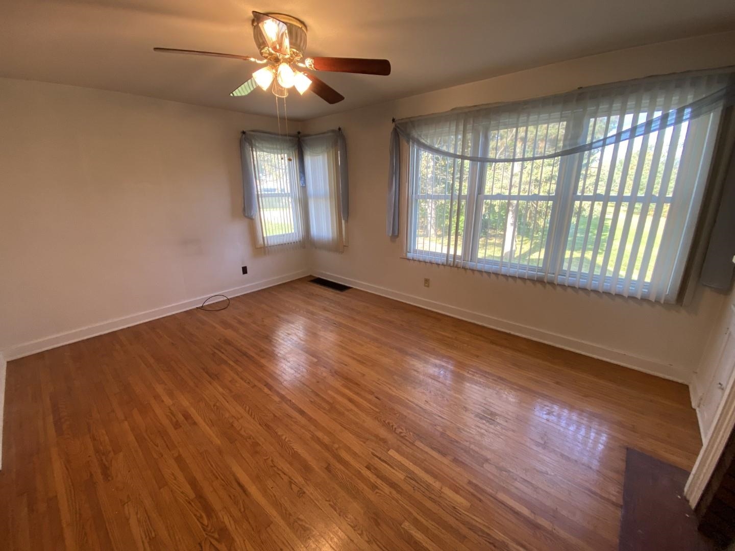 10361 Becker Road Savanna, IL 61074 - Photo 9 of 23 a view of an empty room with wooden floor and a window