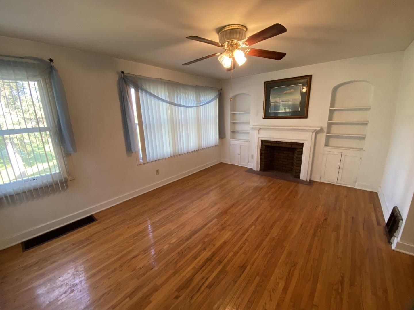 10361 Becker Road Savanna, IL 61074 - Photo 10 of 23 a view of empty room with wooden floor and fan