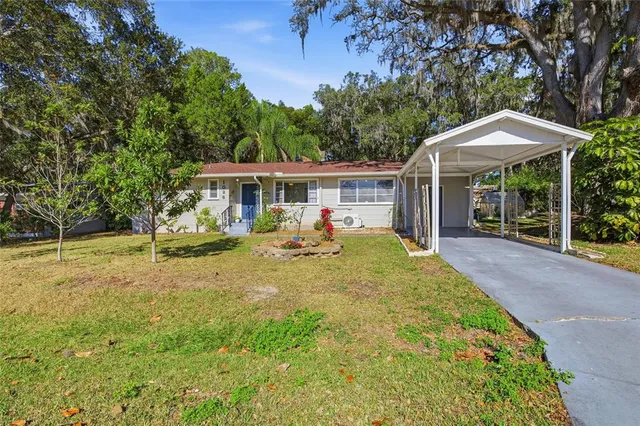 a view of a house with a yard patio and a garden