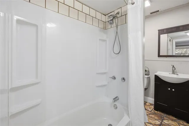 a bathroom with a shower curtain and a sink