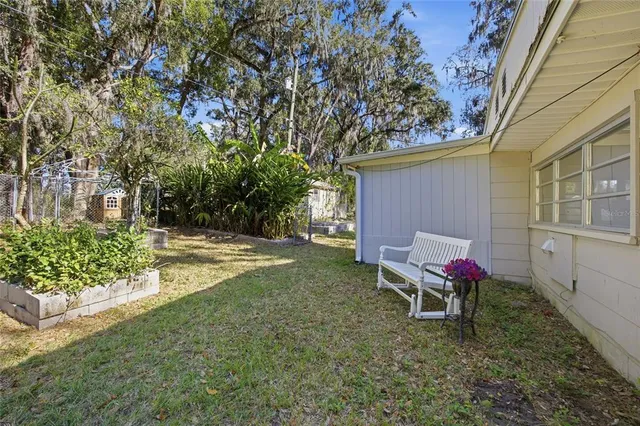 a backyard of a house with table and chairs