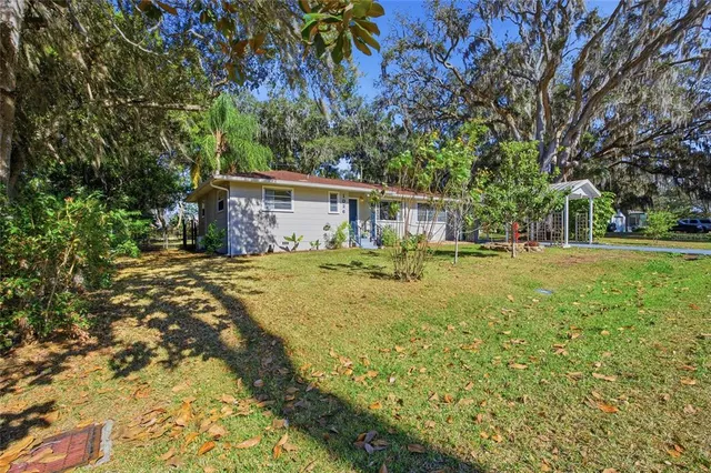 a front view of house with yard and outdoor seating