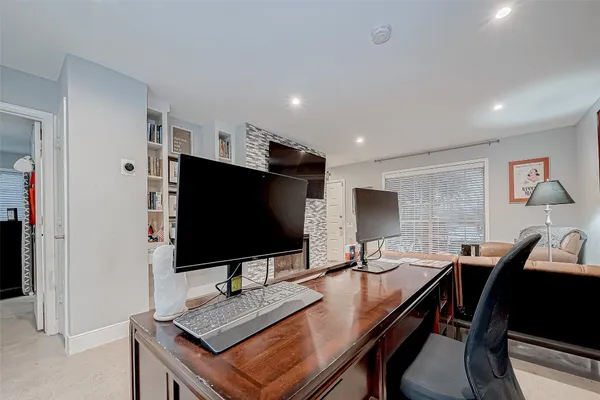 a room with fireplace and television