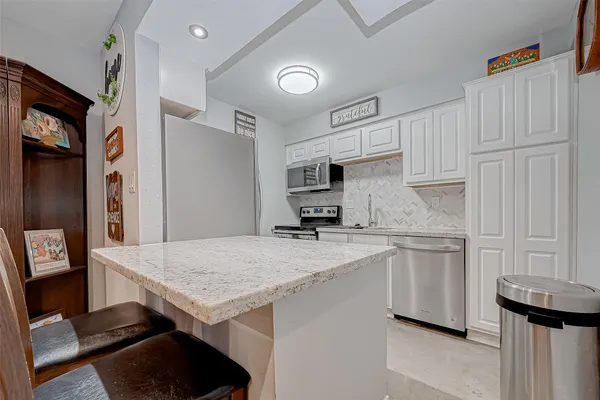 a kitchen with a table and chairs in it