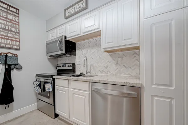 a close view of a stove a microwave and cabinets
