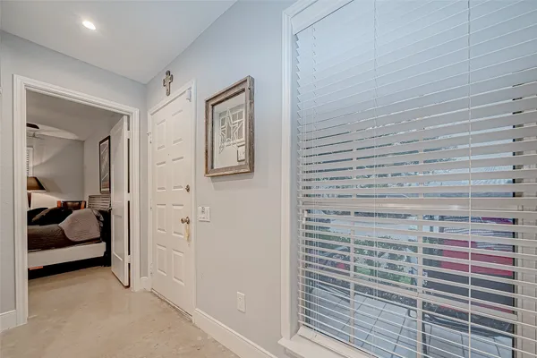 a living room with furniture a clock and a view of bathroom