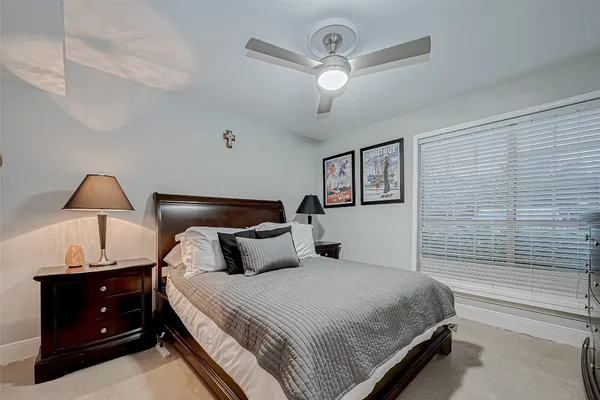 a bedroom with a bed and a mirror