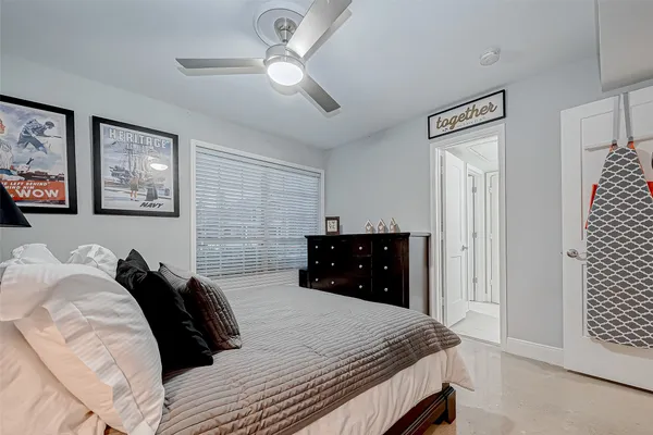 a bedroom with bed and a large window