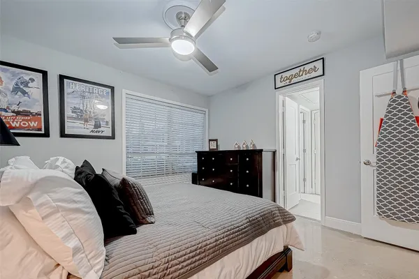 a bedroom with bed and a large window