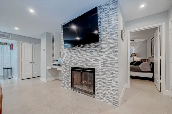 a living room with fireplace furniture and a flat screen tv