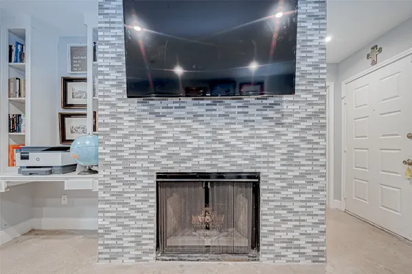 a living room with fireplace furniture and a flat screen tv