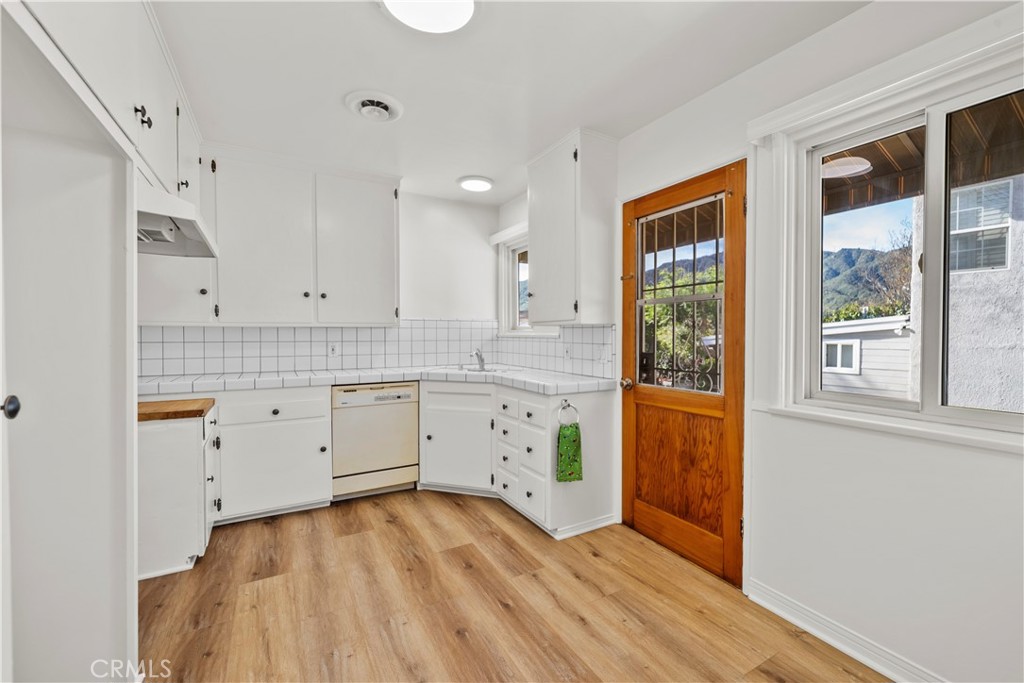 3318 Prospect Avenue La Crescenta, CA 91214 - Photo 18 of 42 a kitchen with white cabinets and wooden floors