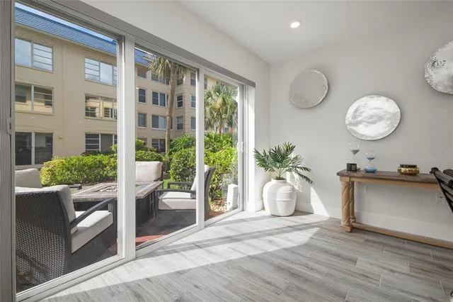 a view of a livingroom with furniture and floor to ceiling window