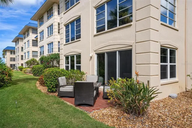 a view of a building with potted plants and more windows