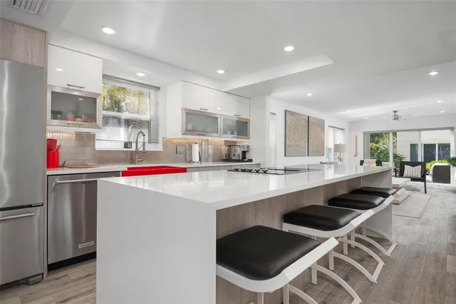 a kitchen with stainless steel appliances kitchen island granite countertop a sink and cabinets