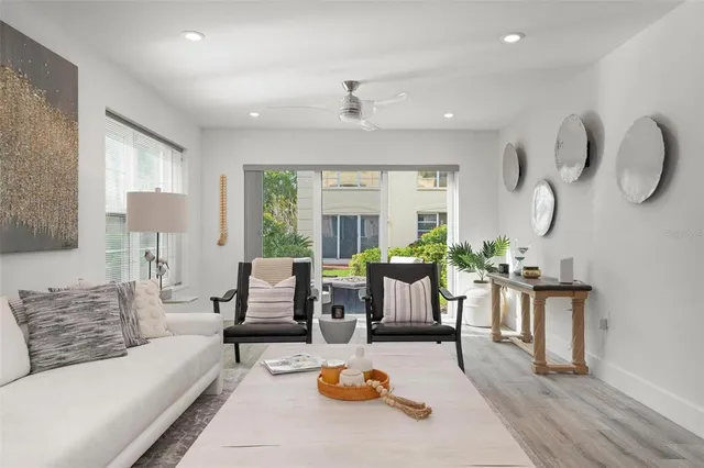 a living room with furniture couches and a large window