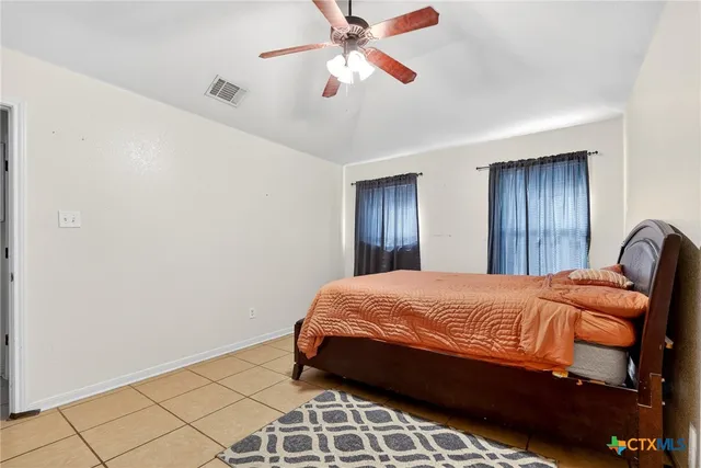 a bathroom with a tub shower sink and vanity