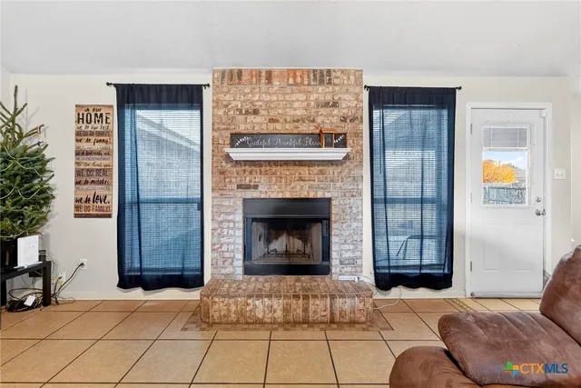 a bedroom with a bed and a fireplace